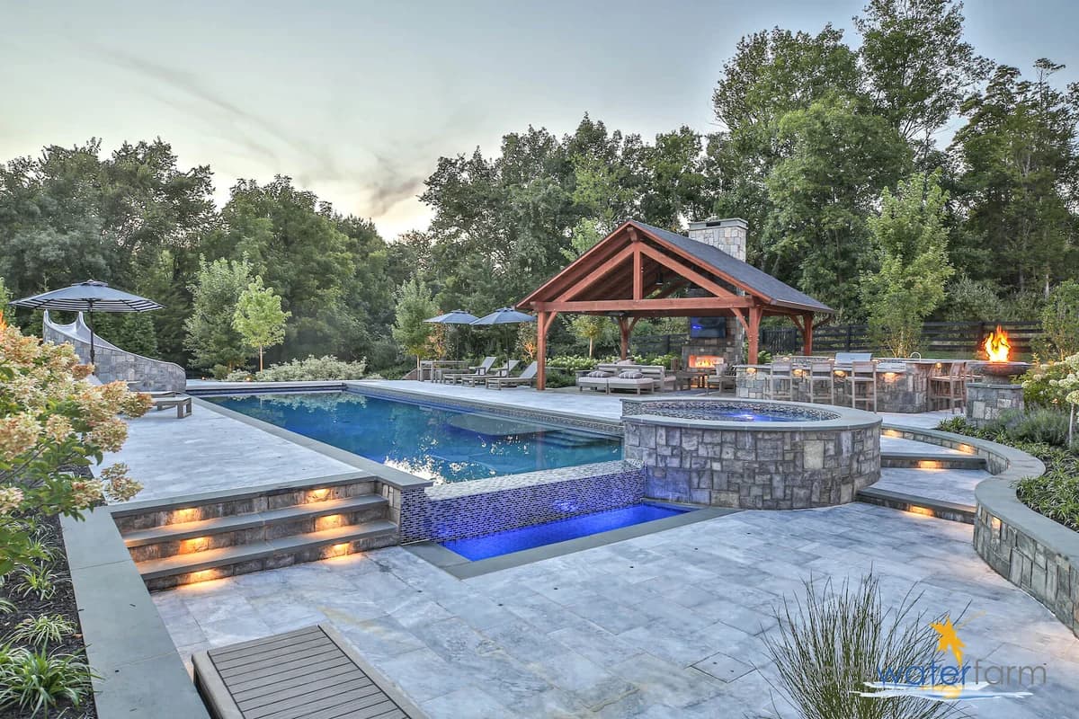 Timber pergola over an outdoor living space at dusk in the Ozarks